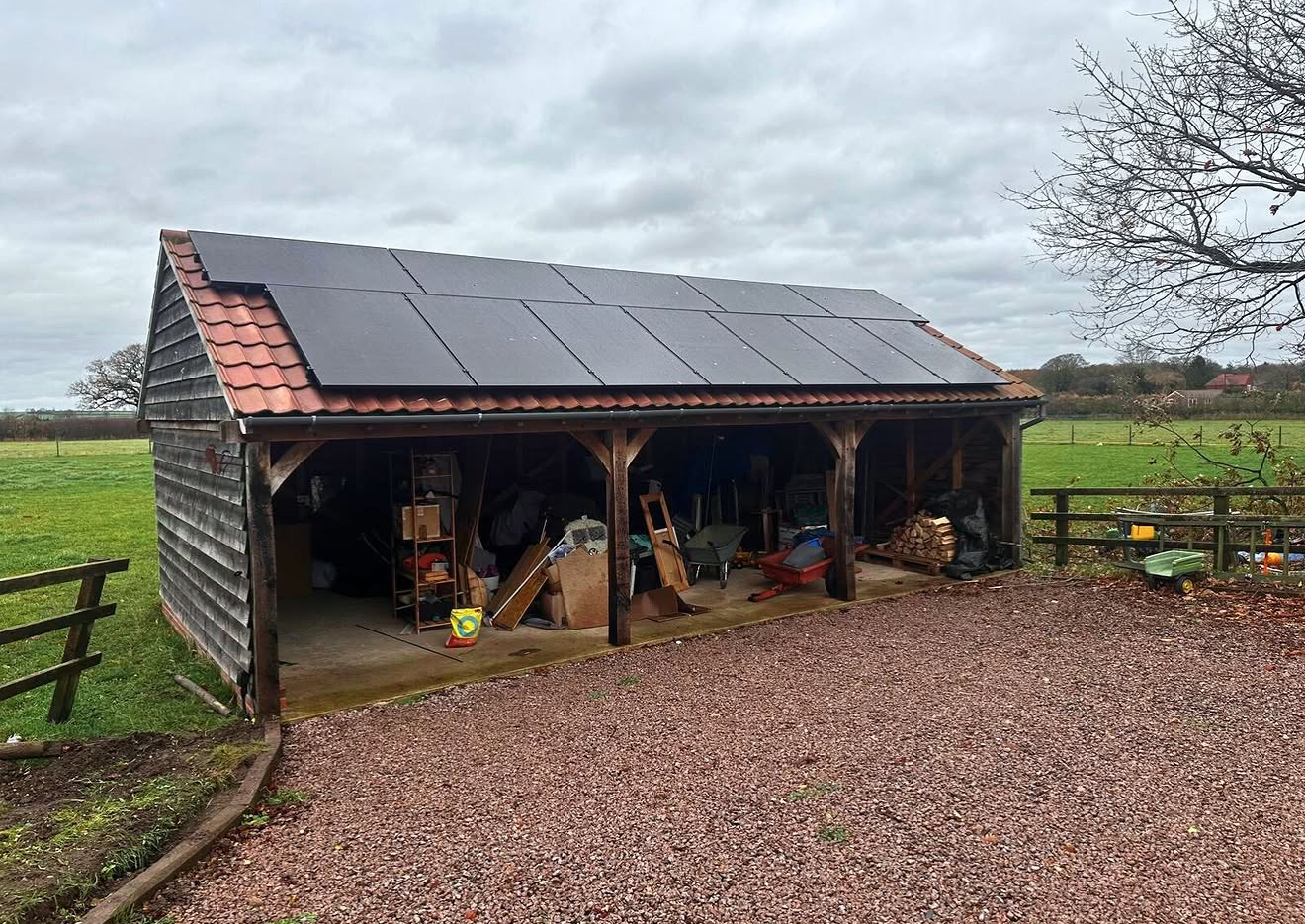 Timber barn with solar panels on its tiled roof