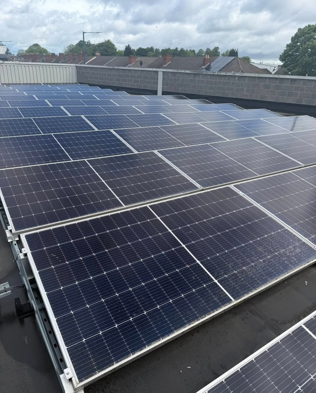 Large commercial flat roof covered with solar panel rows