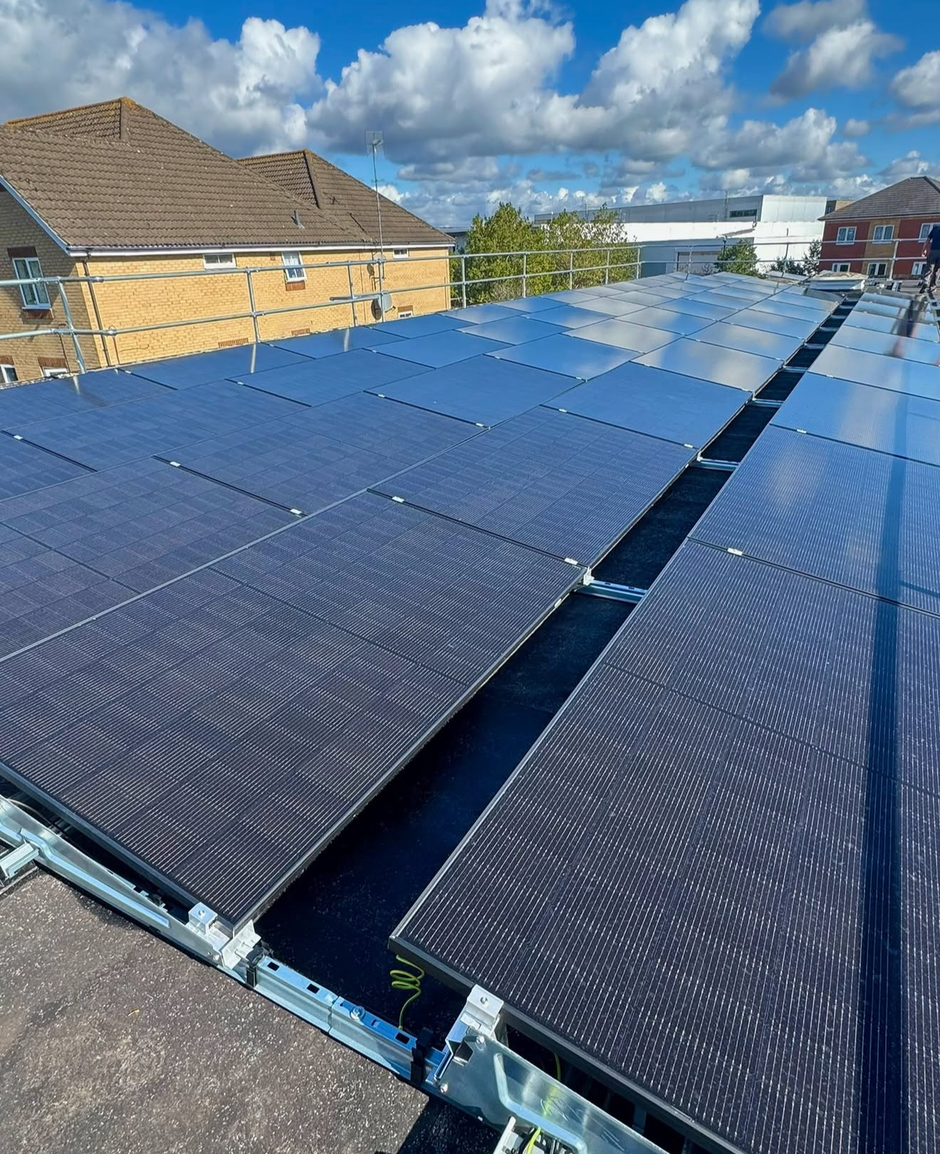 Large urban flat-roof solar installation between houses