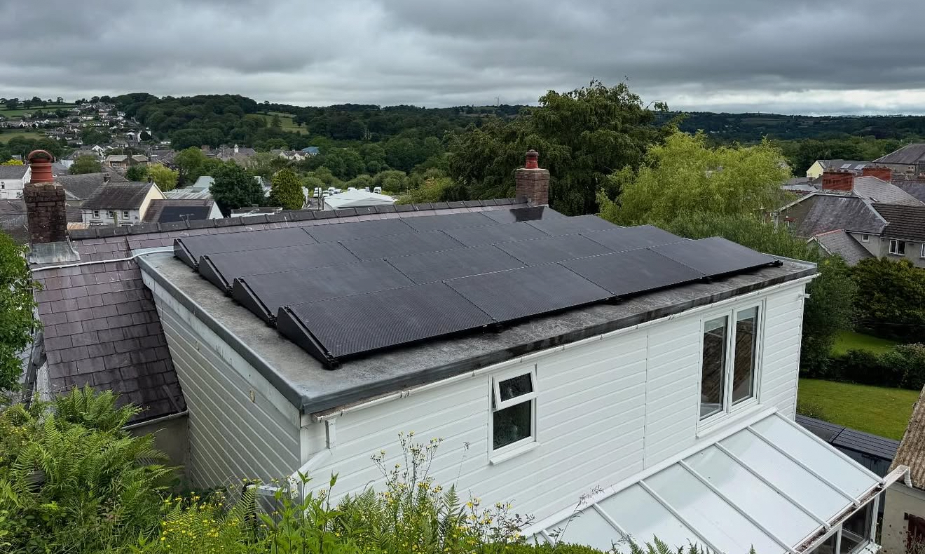 White house with solar panels on a flat roof section