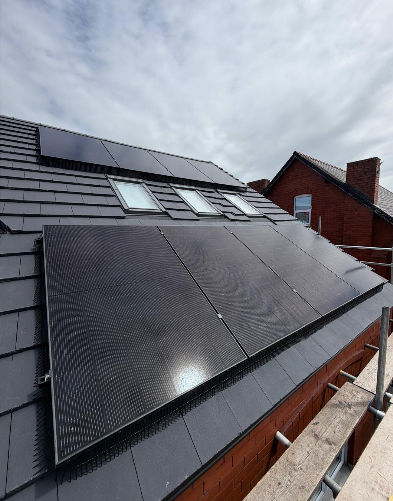 Solar panels around roof windows on a converted roof