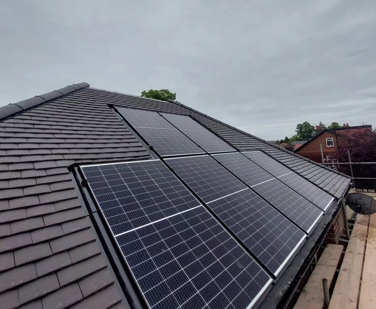 Solar panel array on a grey slate roof seen from above