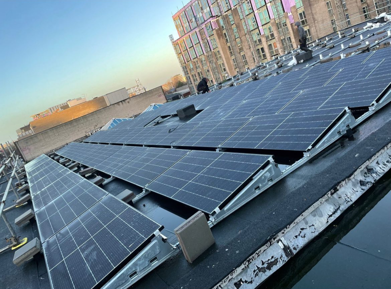 Flat commercial roof with solar panels on angled mounting frames